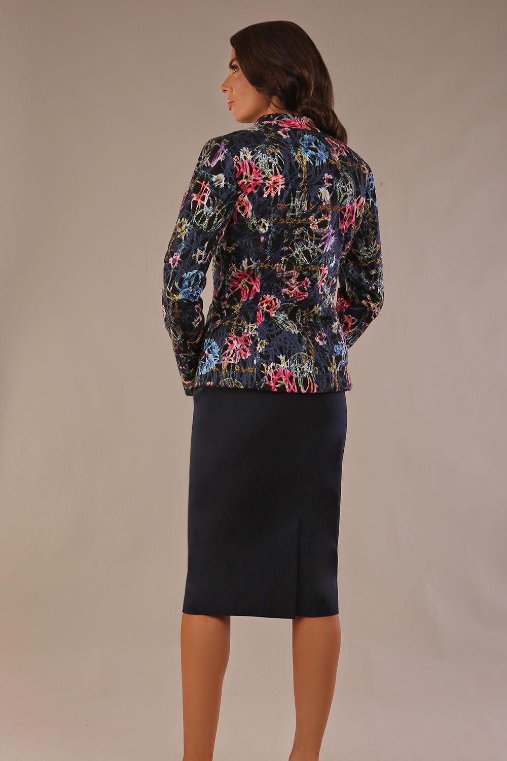 Back image of model wearing a classic Ingrid pencil skirt in dark navy blue with a sophisticated jacket