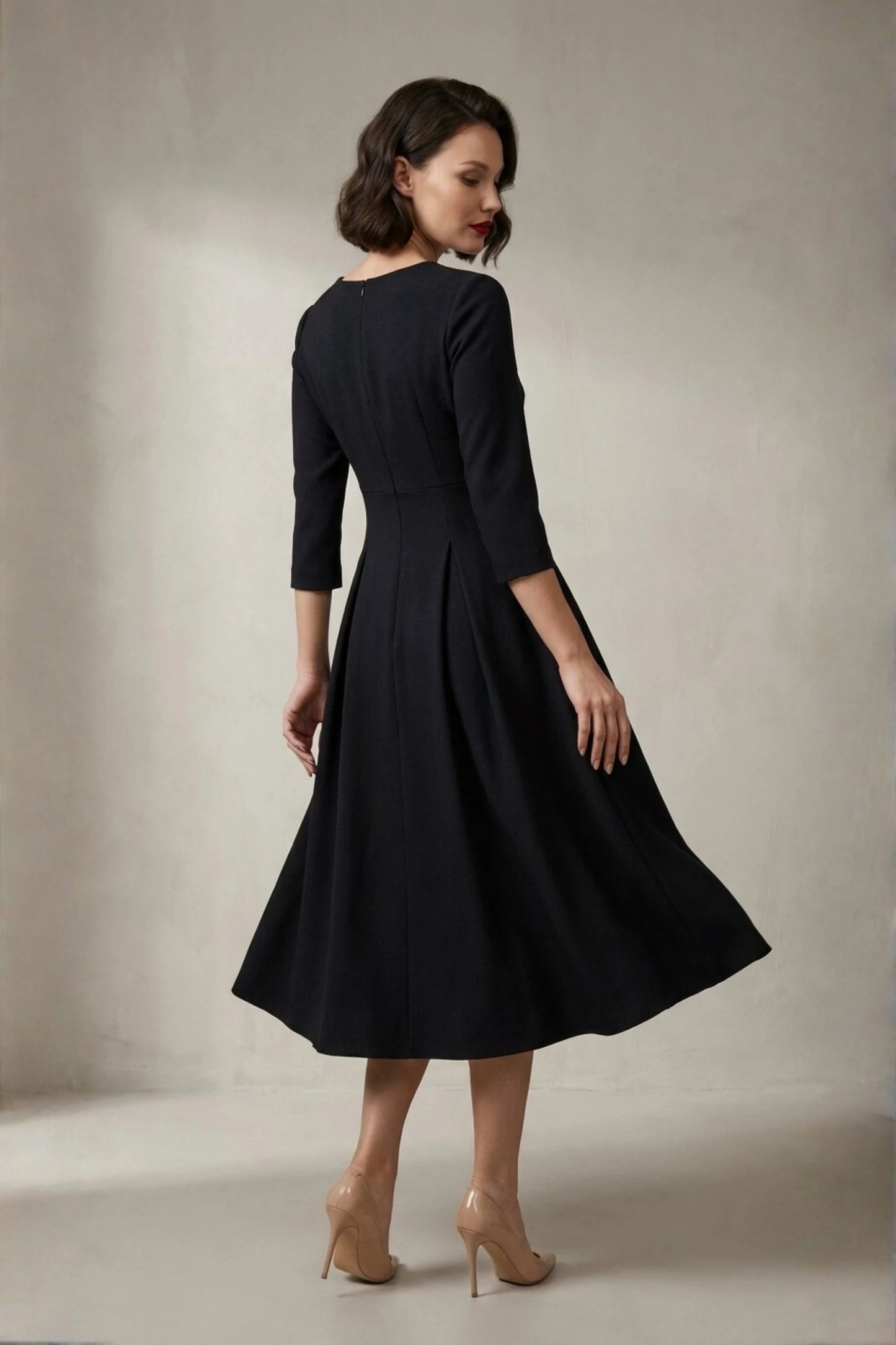 Woman wearing a diva catwalk Amanda Pleated a-line dress in a magenta pink colour against a beige background (Black)