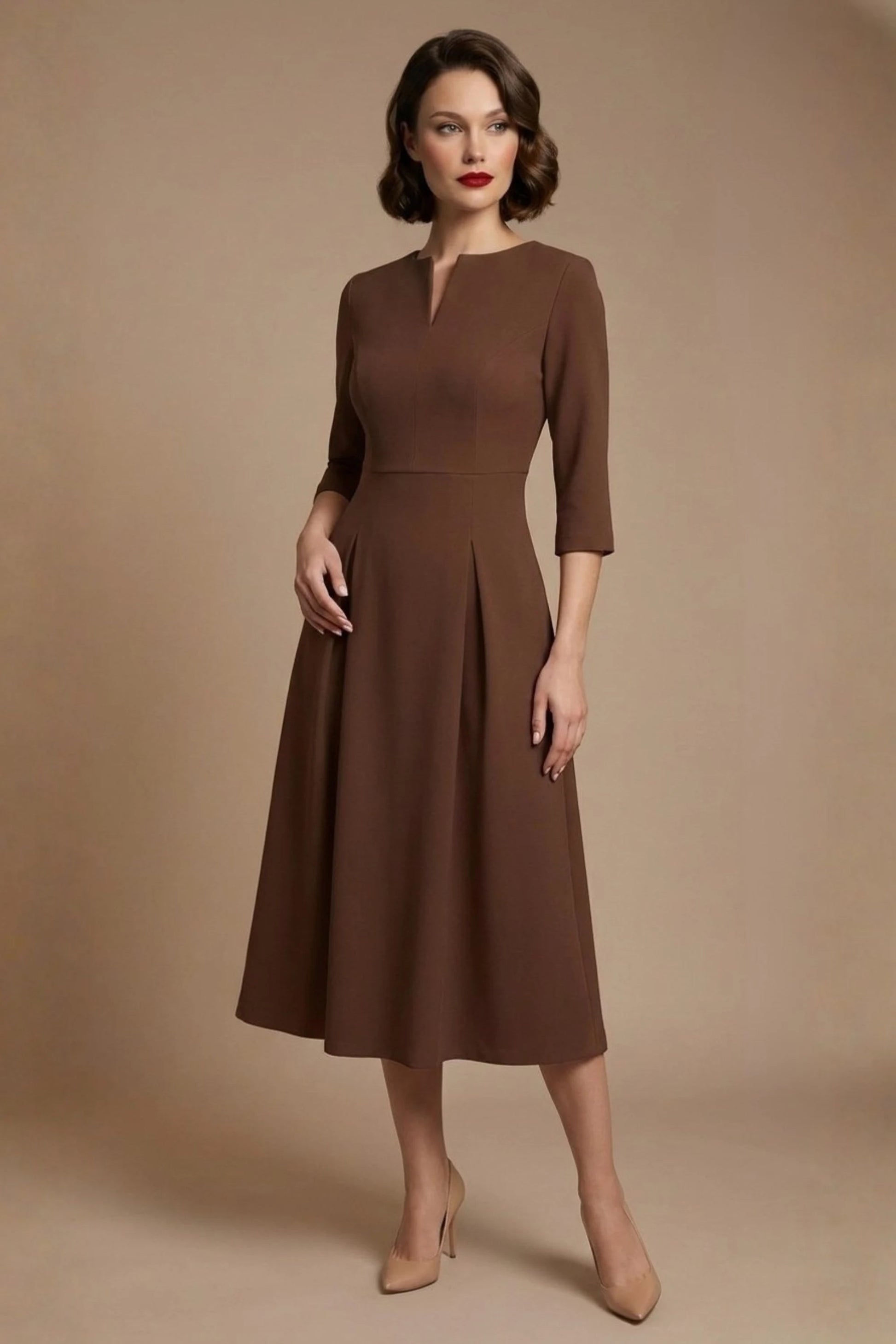 Woman wearing a diva catwalk Amanda Pleated a-line dress in a magenta pink colour against a beige background (Peppercorn Brown)