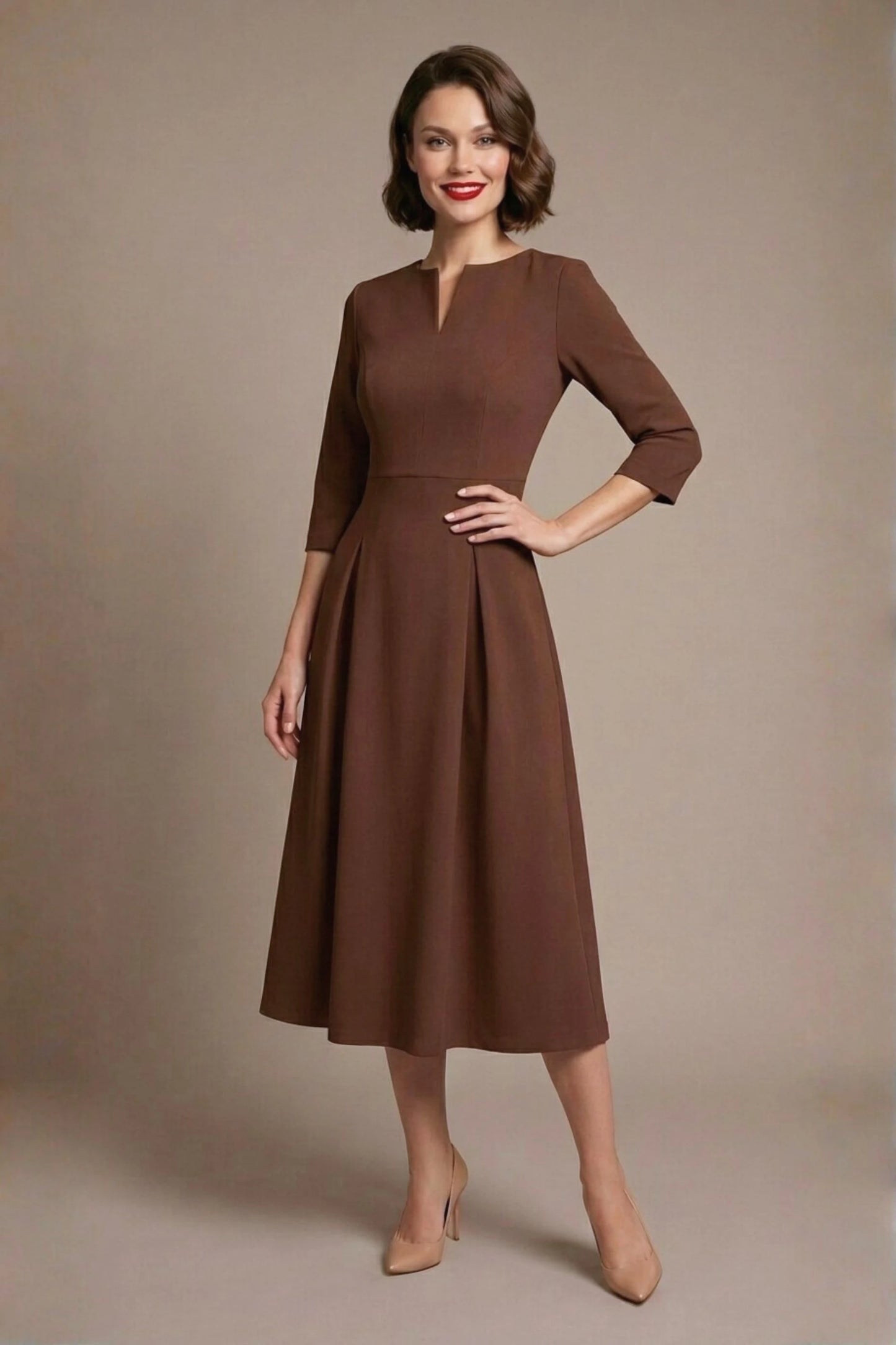 Woman wearing a diva catwalk Amanda Pleated a-line dress in a magenta pink colour against a beige background (Peppercorn Brown)