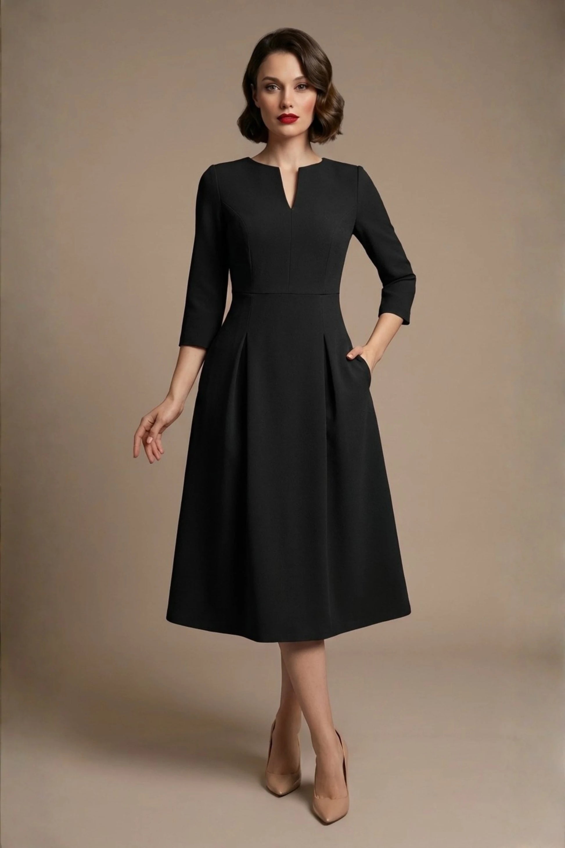 Woman wearing a diva catwalk Amanda Pleated a-line dress in a magenta pink colour against a beige background (Black)