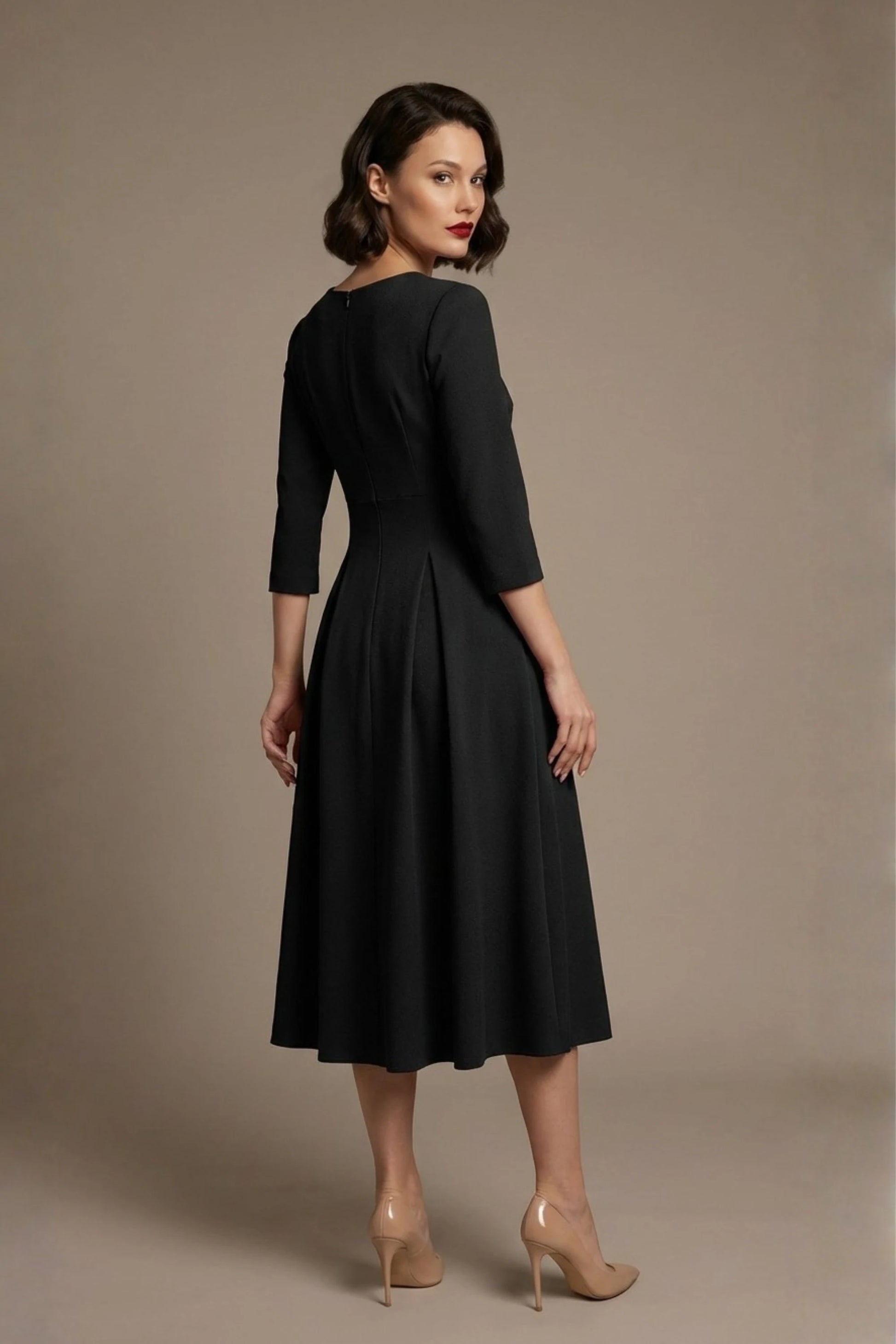 Woman wearing a diva catwalk Amanda Pleated a-line dress in a magenta pink colour against a beige background (Black)