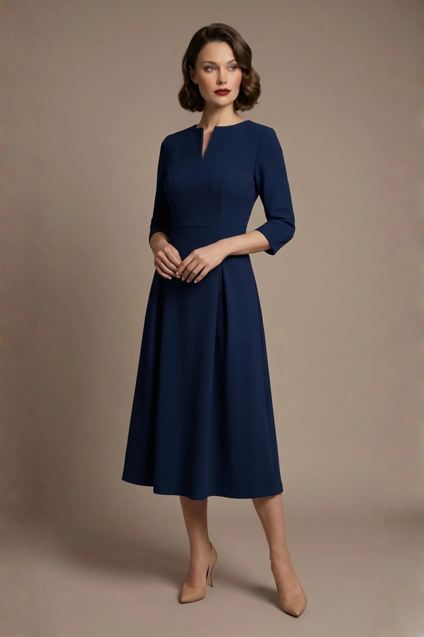 Woman wearing a diva catwalk Amanda Pleated a-line dress in a magenta pink colour against a beige background (Navy Blue)