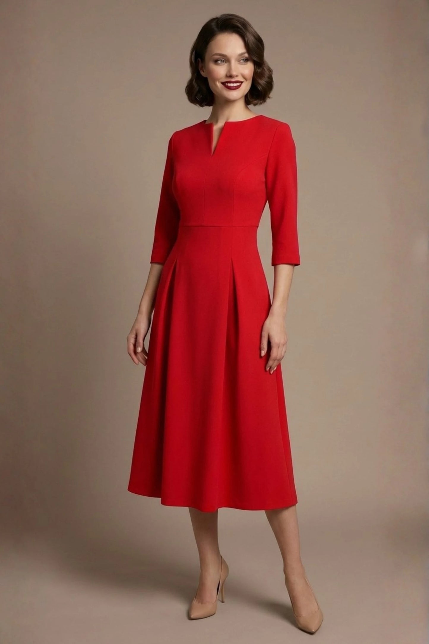 Woman wearing a diva catwalk Amanda Pleated a-line dress in a magenta pink colour against a beige background (Passion Red)