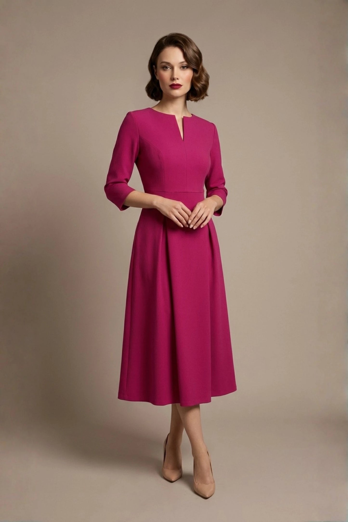 Woman wearing a diva catwalk Amanda Pleated a-line dress in a magenta pink colour against a beige background (Magenta)