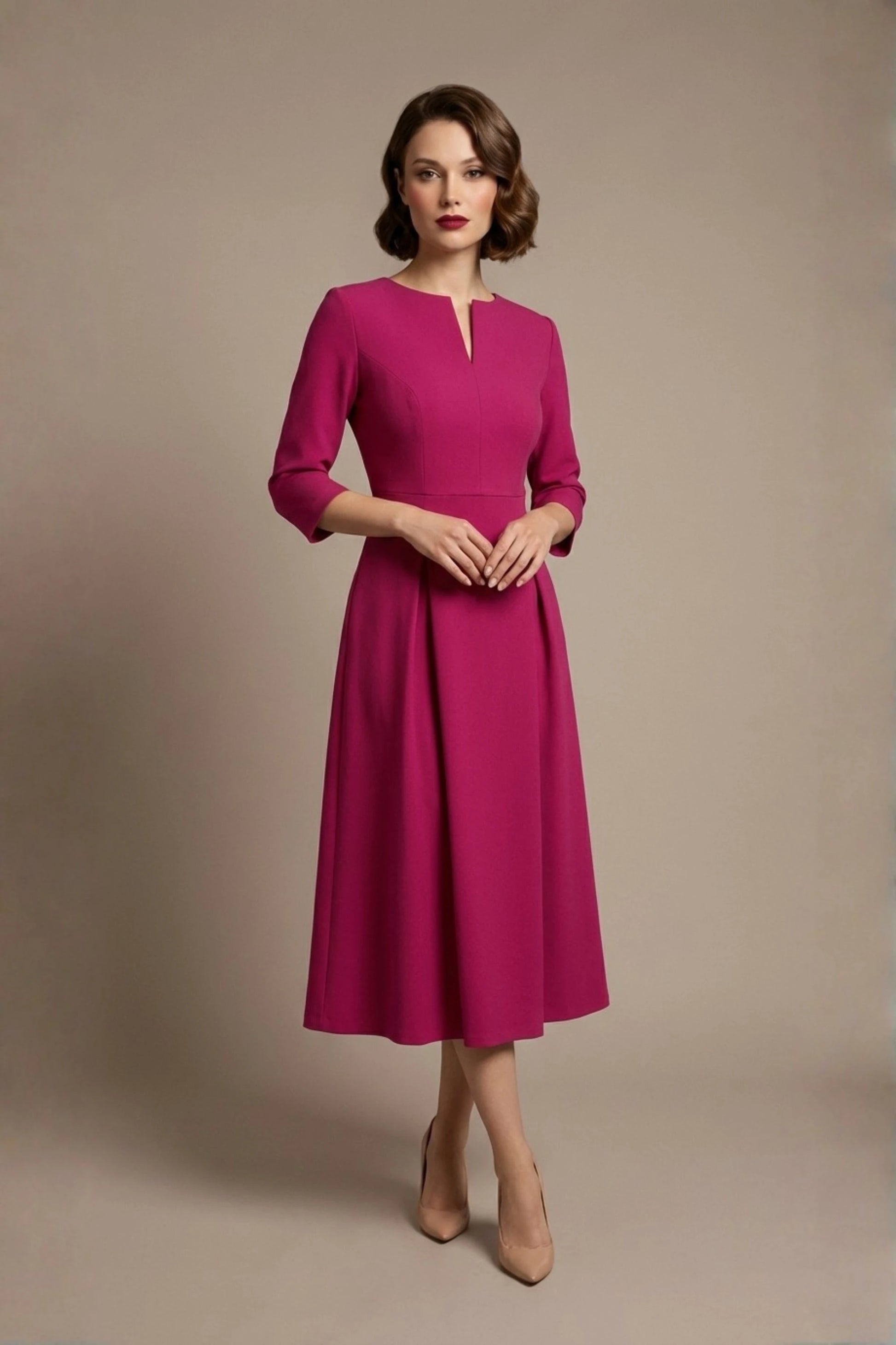 Woman wearing a diva catwalk Amanda Pleated a-line dress in a magenta pink colour against a beige background (Magenta)