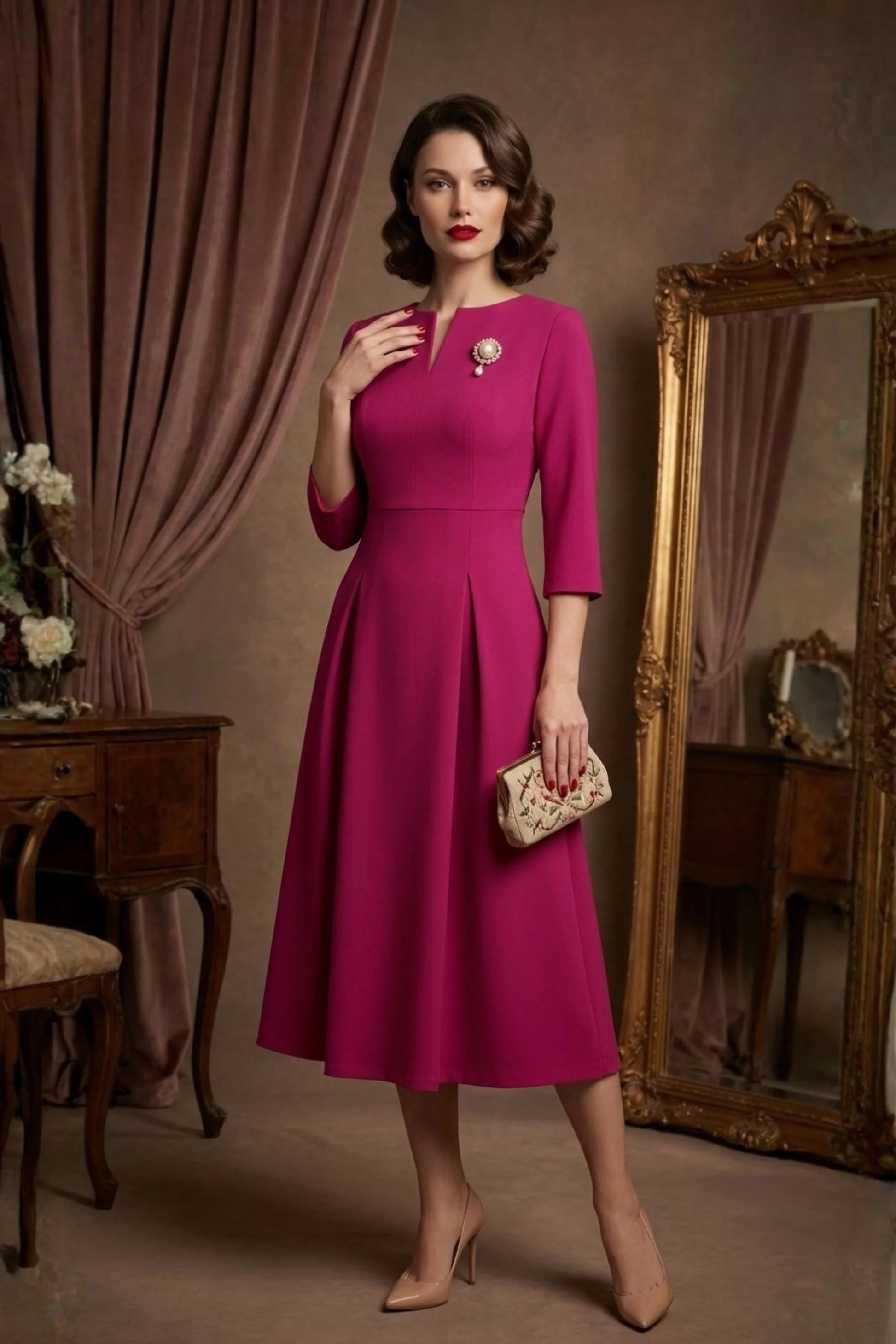 Woman wearing a diva catwalk Amanda Pleated a-line dress in a magenta pink colour standing in a room with a mirror and furniture (Magenta)