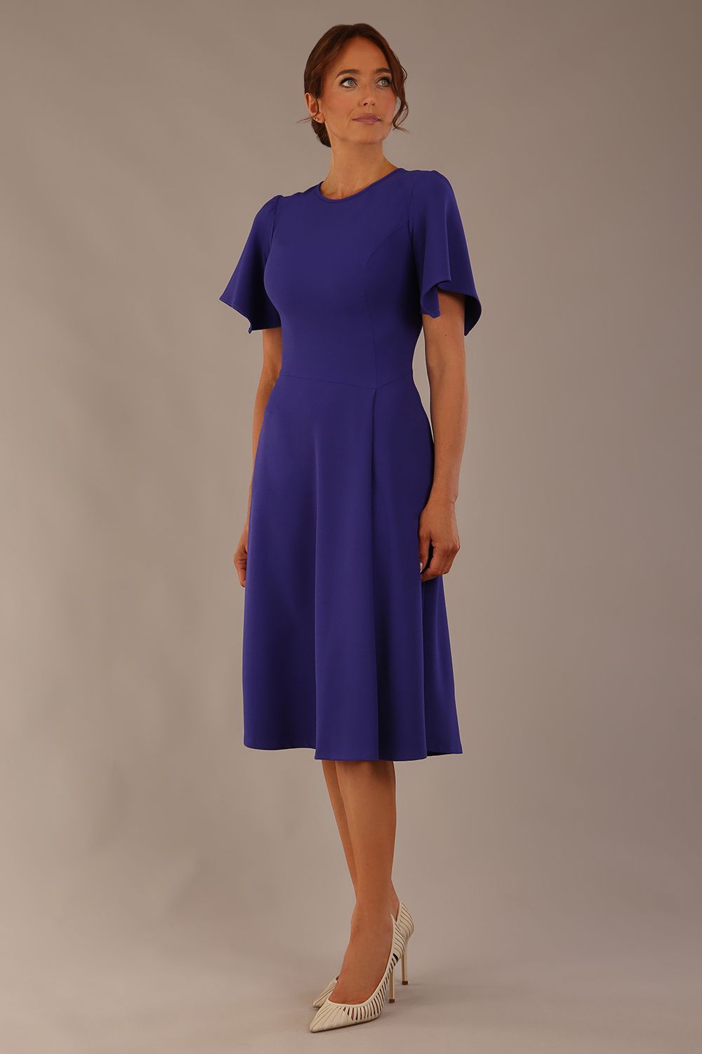 Model wearing a diva catwalk Anders petal sleeve A-line dress against a plain background (Spectrum Indigo)