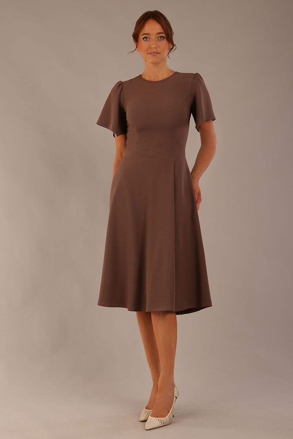 Model wearing a diva catwalk Anders petal sleeve A-line dress against a plain background (Peppercorn Brown)