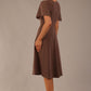 side view Model wearing a diva catwalk Anders petal sleeve A-line dress against a plain background (Peppercorn Brown)