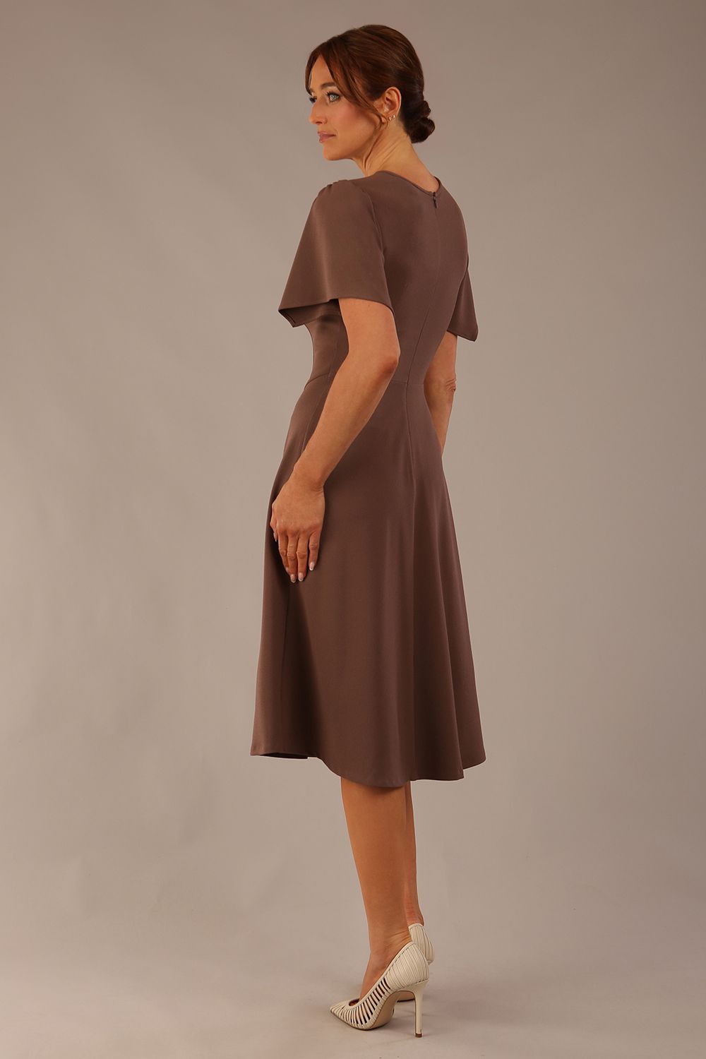 side view Model wearing a diva catwalk Anders petal sleeve A-line dress against a plain background (Peppercorn Brown)