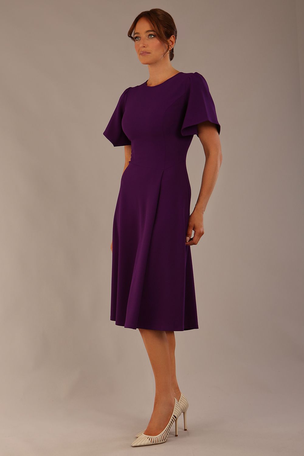 Model wearing a diva catwalk Anders petal sleeve A-line dress against a plain background (Purple)