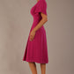 side view Model wearing a diva catwalk Anders petal sleeve A-line dress against a plain background (Magenta)