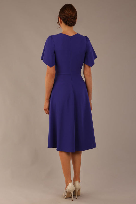 back view Model wearing a diva catwalk Anders petal sleeve A-line dress against a plain background (Spectrum Indigo)