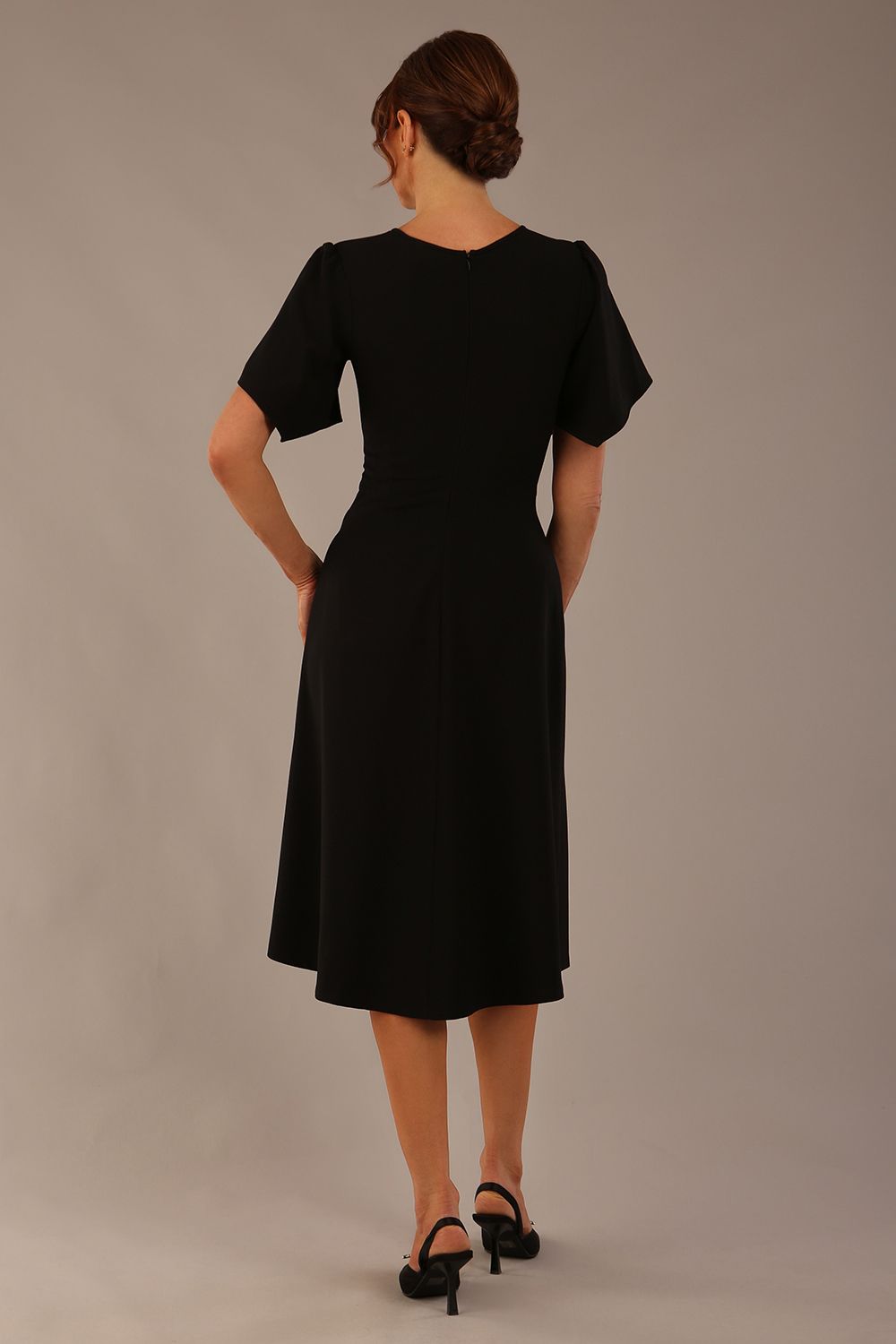 back view Model wearing a diva catwalk Anders petal sleeve A-line dress against a plain background (Black)