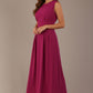 Model wearing the Cleo pleated midaxi dress in magenta with discreet side pockets.