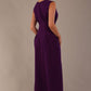 Back view of the Cleo dress in purple, showing the continuation of the pleat detail and A-line skirt.