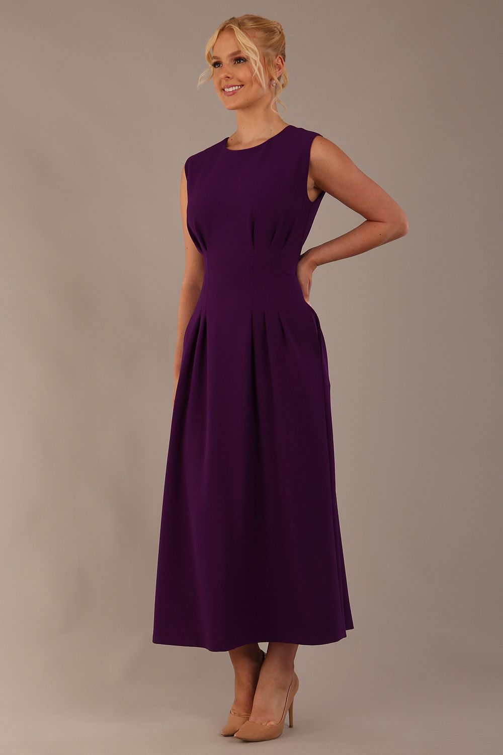Side view of the Cleo midaxi dress, highlighting the flattering silhouette and pleated skirt.