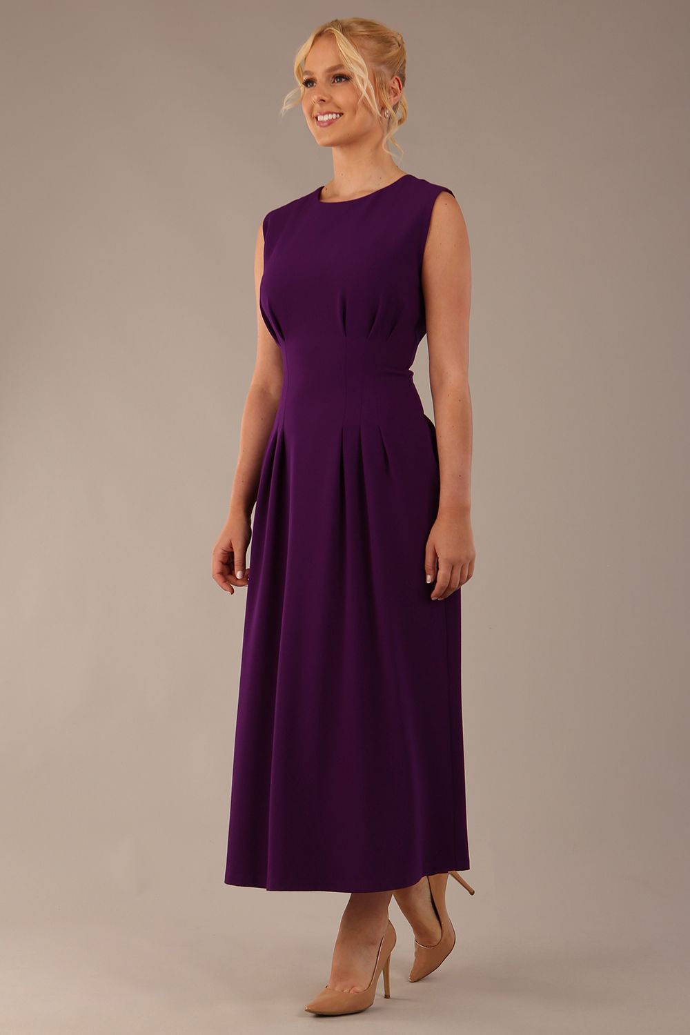 Side view of the Cleo midaxi dress, highlighting the flattering silhouette and pleated skirt.