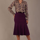 Model wearing the Truro floral top, showing the standard hip-length and draped V-neck and purple marlene skirt against a gray background