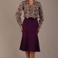 Model wearing the Truro floral top, showing the standard hip-length and draped V-neck and purple marlene skirt against a gray background