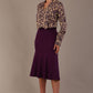 Model wearing the Truro floral top, showing the standard hip-length and draped V-neck and purple skirt against a beige background