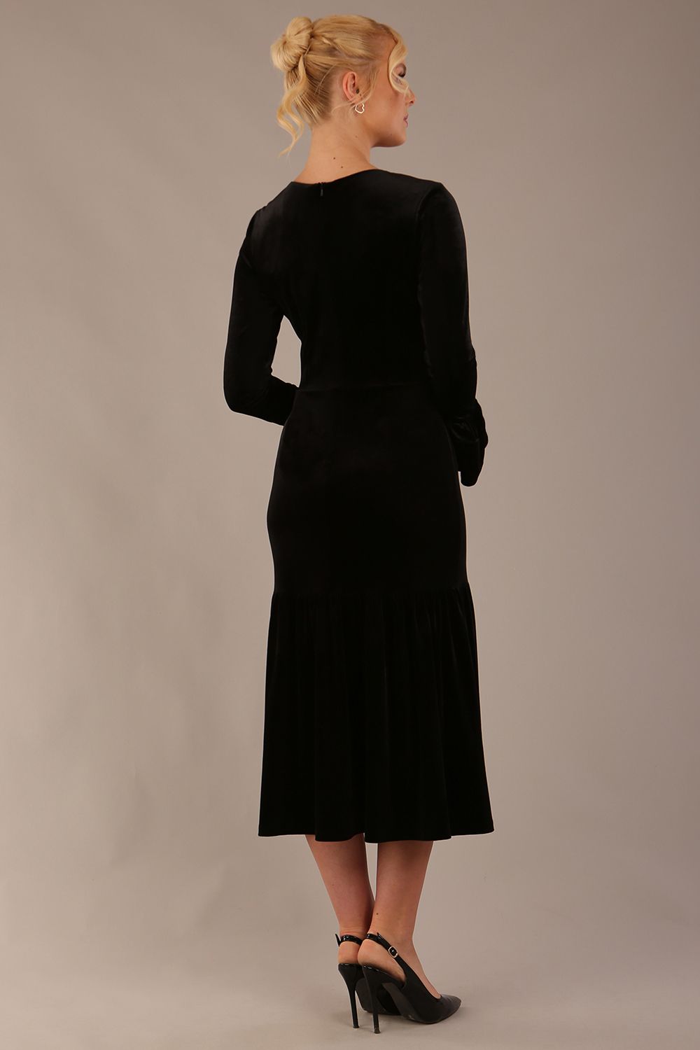 Back view of the Sophisticat velvet midi dress, showing the tailored fit and fluted hem.