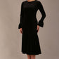 Side view of the Sophisticat dress, showcasing the layered fluted cuffs and fishtail silhouette.
