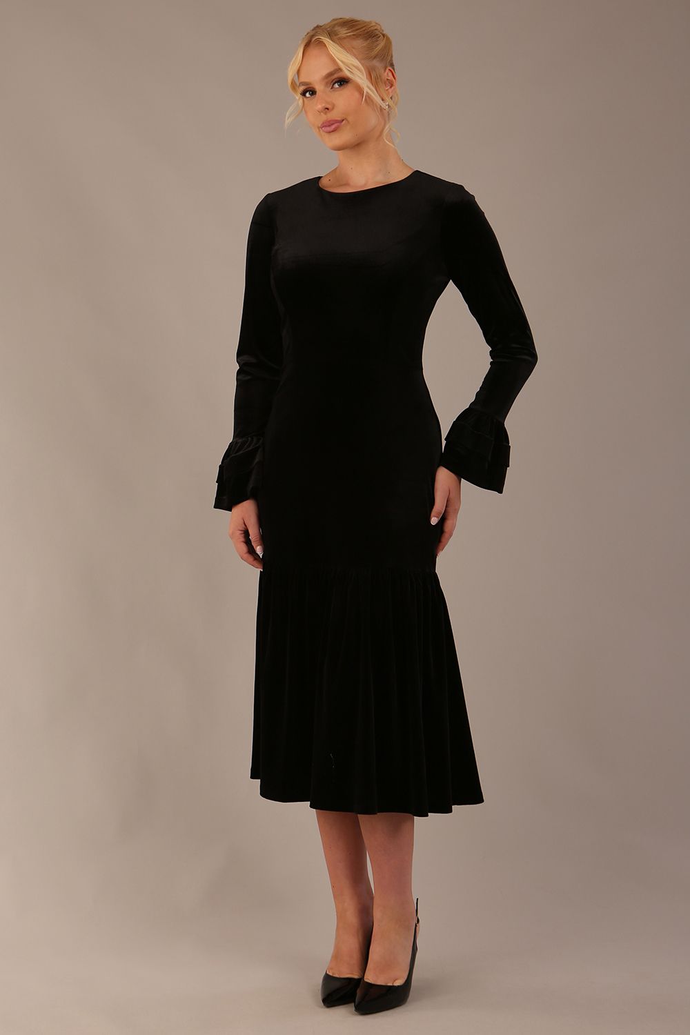 Side view of the Sophisticat dress, showcasing the layered fluted cuffs and fishtail silhouette.