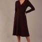 Model wearing the Moneypenny A-line midi dress in decadent fig, showcasing the classic V-neckline.
