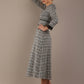 Model wearing the Hendricks check midi dress in misty grey with black lace cuffs and a V-neck (Misty Grey Check)