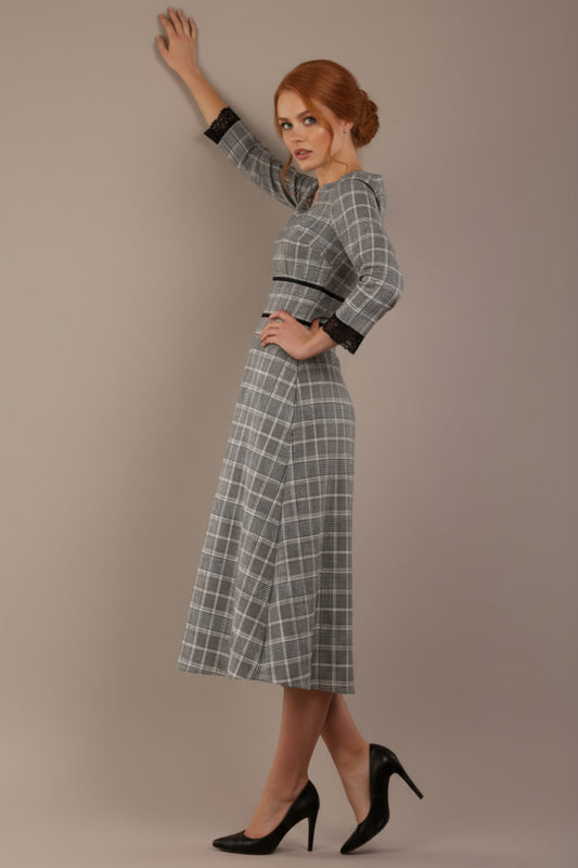 Model wearing the Hendricks check midi dress in misty grey with black lace cuffs and a V-neck