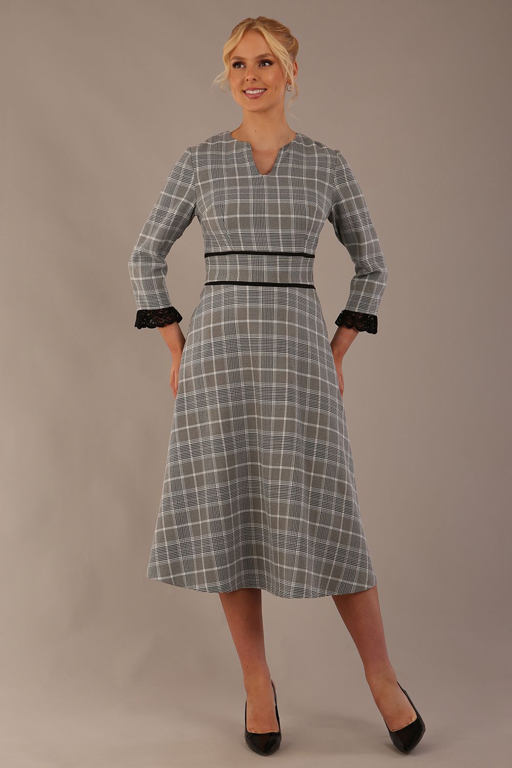 Model wearing the Hendricks check midi dress in misty grey with black lace cuffs and a V-neck.