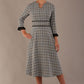 Model wearing the Hendricks check midi dress in misty grey with black lace cuffs and a V-neck.
