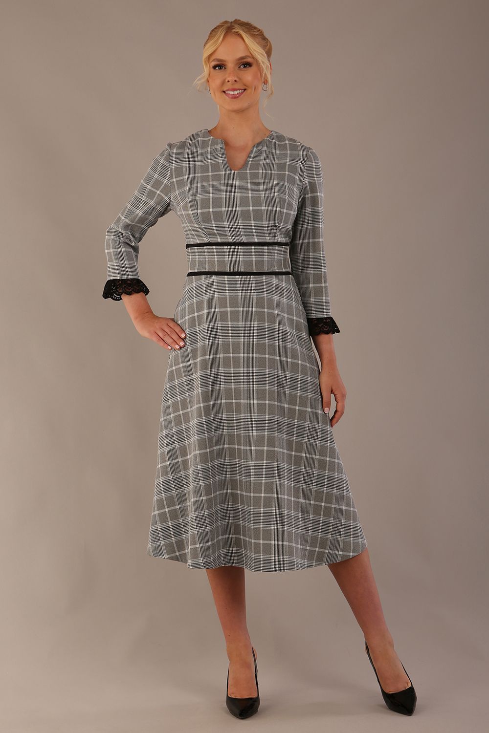 Model wearing the Hendricks check midi dress in misty grey with black lace cuffs and a V-neck.
