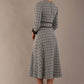 Model wearing the Hendricks check midi dress in misty grey with black lace cuffs and a V-neck (Misty Grey Check)