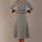 Model wearing the Hendricks check midi dress in misty grey with black lace cuffs and a V-neck (Misty Grey Check)