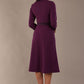 Back view of the Sybil dress in imperial purple, showing the elegant high back with its split satin collar detail. (Imperial Purple)