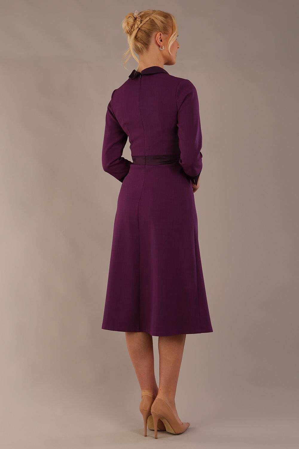 Back view of the Sybil dress in imperial purple, showing the elegant high back with its split satin collar detail. (Imperial Purple)