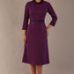 Model wearing the Sybil A-line midi dress in imperial purple with a satin cowl neck and waistband (Imperial Purple)