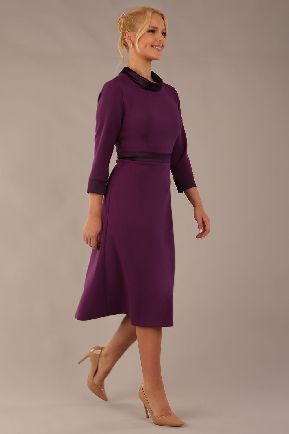 Model walking in the Sybil dress, showing the fluid movement of the A-line midi skirt (Imperial Purple)
