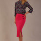 Blonde model wearing a fuchsia pink Claudette pencil skirt, showing the profile view with side buttons.