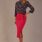 Blonde model wearing a fuchsia pink Claudette pencil skirt, showing the profile view with side buttons.