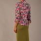 Model wearing a Radley Floral Tango print top with a central tie neckline and 3/4 sleeves, styled with an olive green skirt.