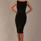 Model wearing the Rialto sleeveless pencil dress in black, showing the boat neckline and satin waistband.