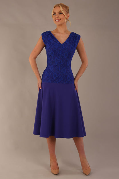 Model wearing the Ayesha lace bodice A-line dress in spectrum indigo. (Spectrum Indigo)