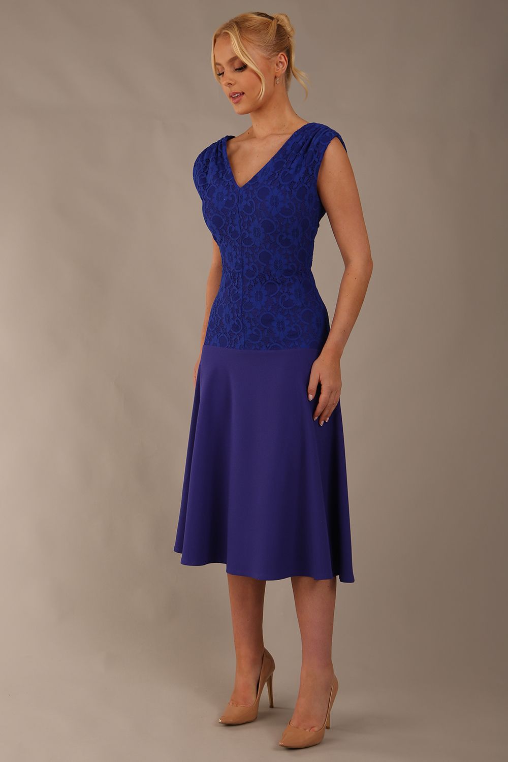 Model wearing the Ayesha lace bodice A-line dress in spectrum indigo. (Spectrum Indigo)