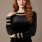 Woman wearing a black dress with gold accents on a beige background (Black Velvet with Sherwood Glitter Contrast)