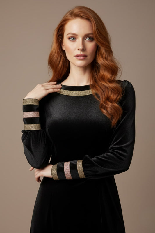 Woman wearing a black dress with gold accents on a beige background (Black Velvet with Sherwood Glitter Contrast)
