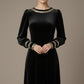 Model wearing the diva catwalk Spinetti long-sleeved jewelled velvet midi dress in black front close up